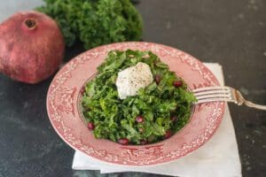 Kale salad with pomegranate seeds and dressing