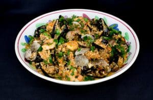 Mediterranean seafood couscous in decorative bowl