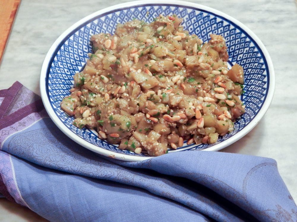Roasted eggplant dish garnished with herbs