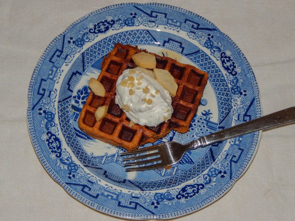 Square waffle with cream on blue patterned plate
