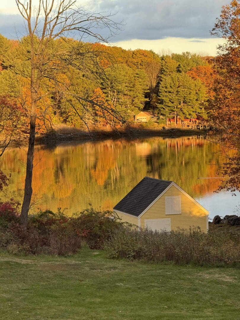Small yellow cottage by a lake