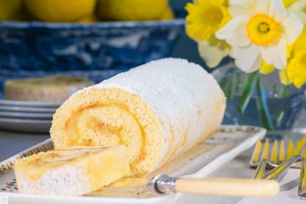 Lemon Swiss roll on decorative platter