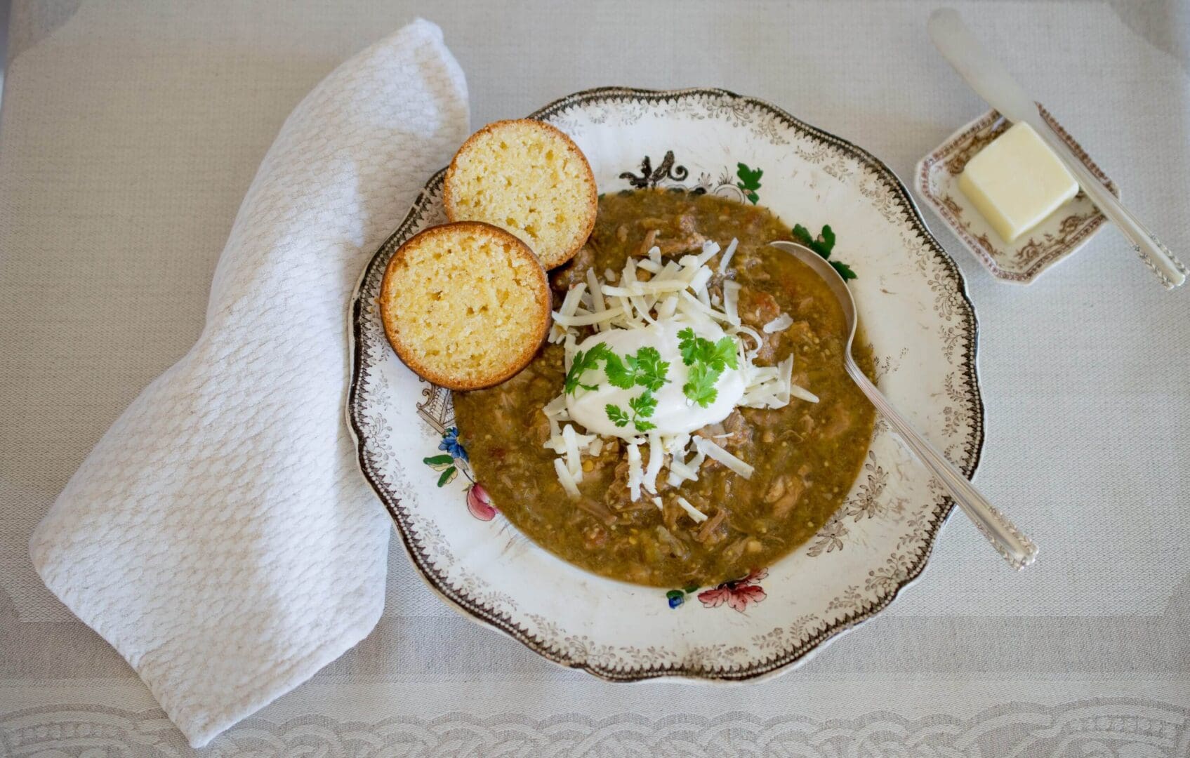Soup with bread and butter on table