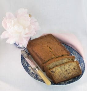 Sliced banana bread with knife and flower
