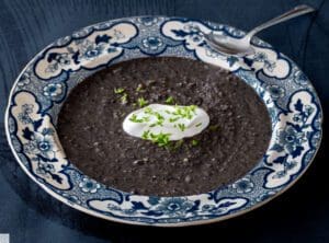 Blue floral bowl of pureed black bean soup