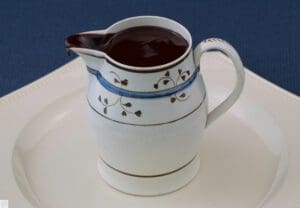 Handpainted jug overflowing glossy chocolate
