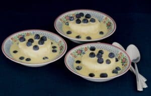 Three bowls of blueberry-topped desserts