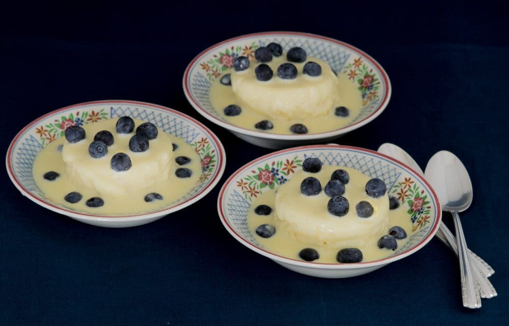 Three bowls of blueberry-topped desserts