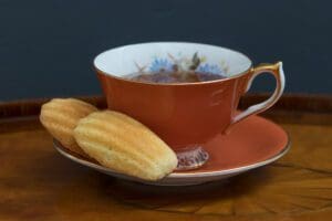 Decorative teacup and biscuits set on table