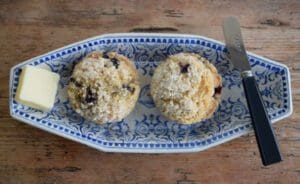 Muffins with butter and knife