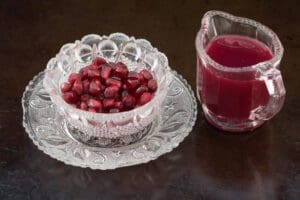Fresh pomegranate juice and seeds display