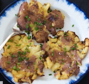 Smashed potatoes on blue-rimmed plate