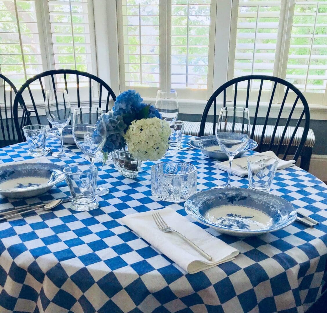 Checkered tablecloth with elegant table setting.