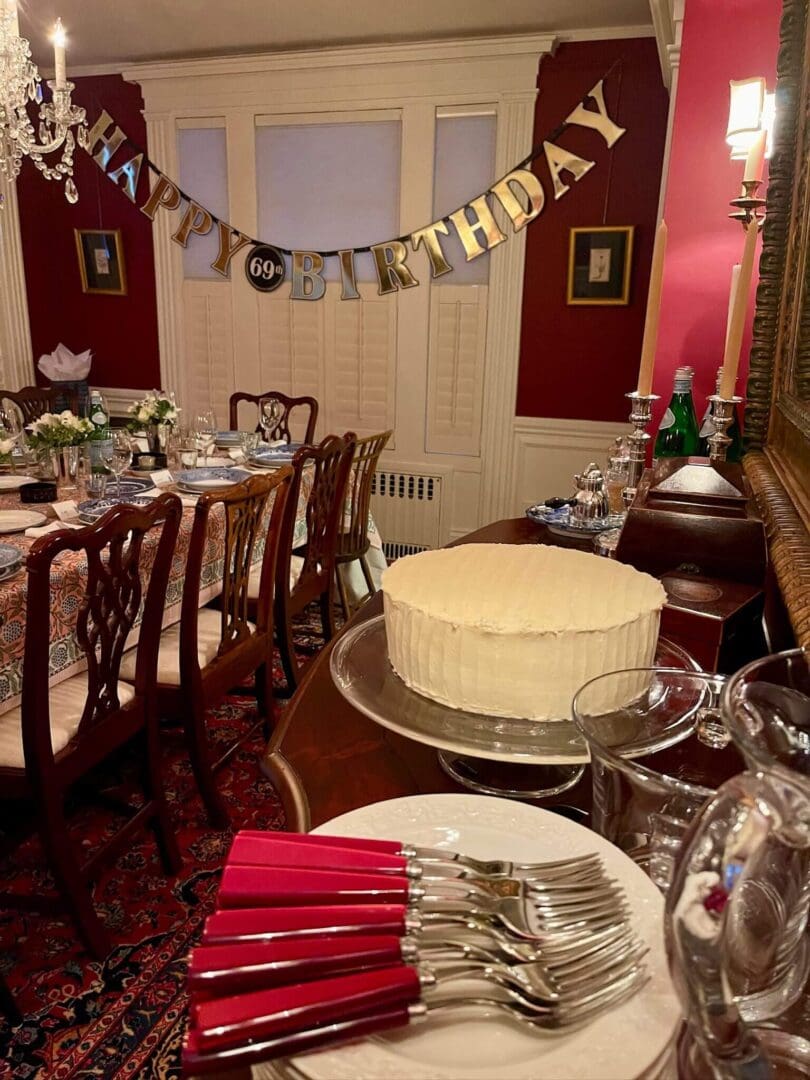 Birthday celebration setup with cake and banner.