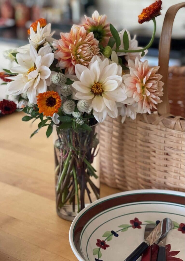 Flowers in vase on wooden table.