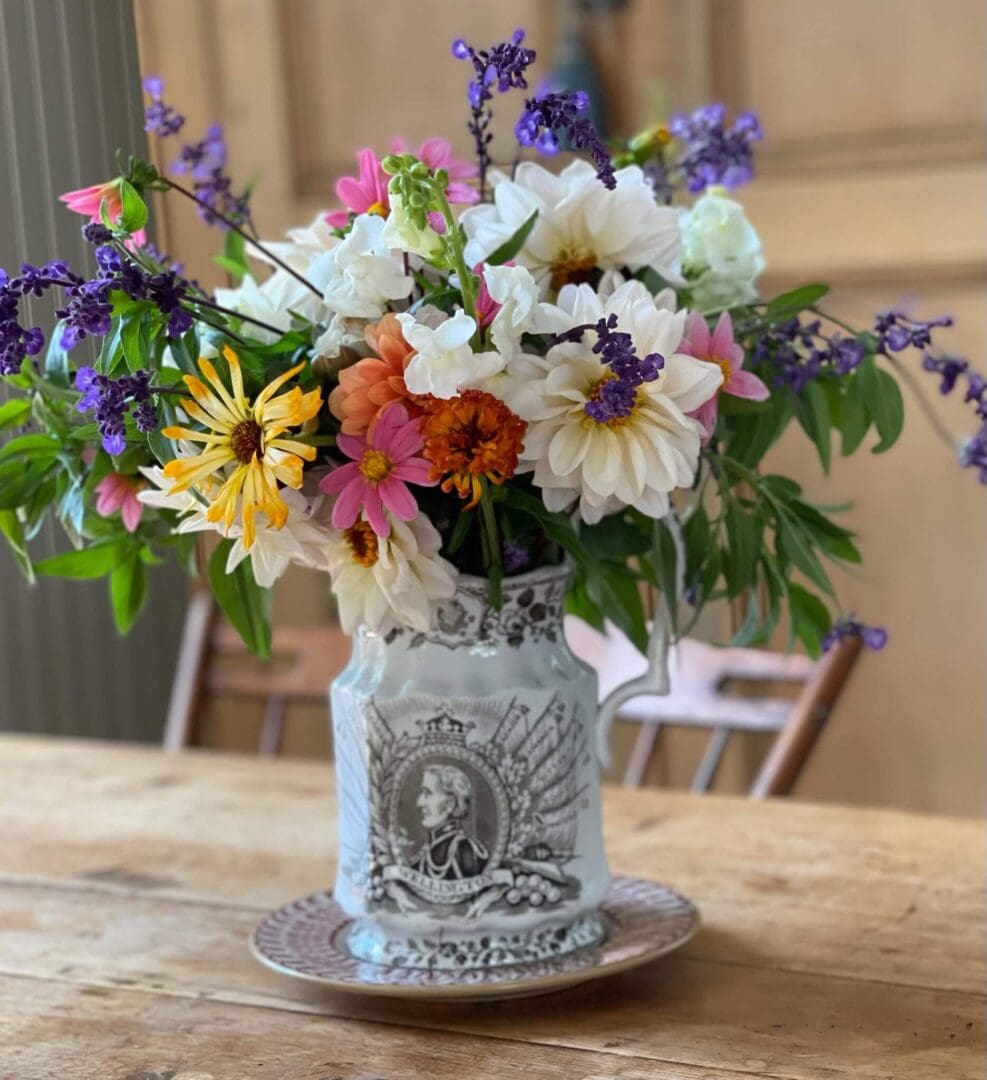 Vibrant flowers in decorative vase on table.